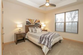 Sun Prairie apartment for rent - a bedroom with a bed and a ceiling fan