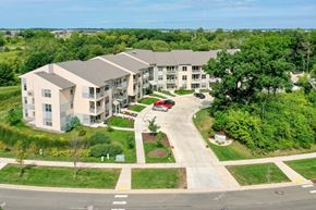 Sun Prairie apartment for rent - an aerial view of an apartment building with a parking lot and trees