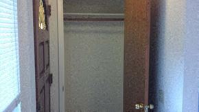 Seaside apartment for rent - A brown door with a brass handle is in a room.