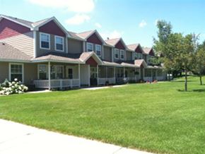 Albany townhouse for rent - A row of houses with green lawns in front.