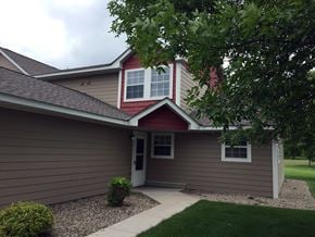 Albany townhouse for rent - A house with a red roof and a brown siding.