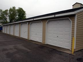 St Cloud townhouse for rent - a row of white garage doors on the side of a building