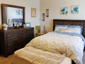 Mahtomedi apartment for rent - a bedroom with a bed and a dresser and a mirror
