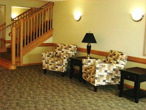 Maple Grove apartment for rent - Two chairs and a table with a lamp on it.