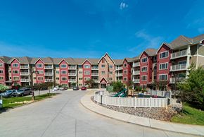 Plymouth apartment for rent - a row of colorful apartment buildings with a playground in front of them