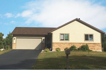 Sartell apartment for rent - a house with a driveway and a garage door