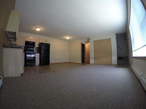 St Cloud townhouse for rent - an empty living room with a kitchen and a large window