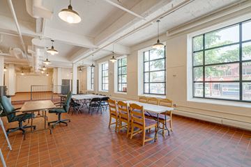 St Paul apartment for rent - a dining room with tables and chairs in a room with large windows