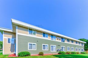 Albany townhouse for rent - an apartment building with green siding and a blue sky
