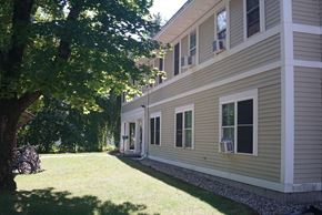 Northampton apartment for rent - A house with a green lawn and a tree in front.