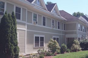 Northampton apartment for rent - A grey house with a brown roof and white trim.