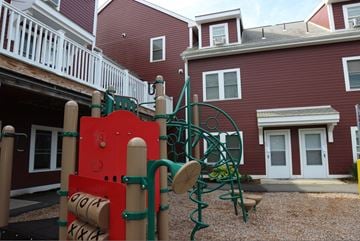 Amherst apartment for rent - a playground in front of a red building