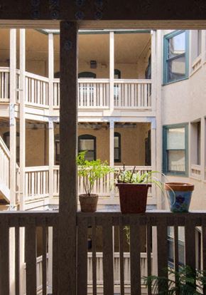 Springfield apartment for rent - two potted plants sitting on a wooden balcony