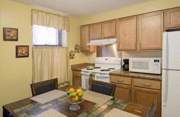 Springfield apartment for rent - a kitchen with white appliances and wooden cabinets