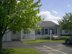 Hadley apartment for rent - a white house with a bench in front of it