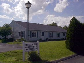 Hadley apartment for rent - a white house with a sign in front of it