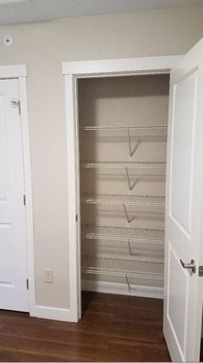 Amherst apartment for rent - an empty closet with empty shelves and a door