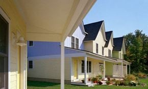 Northampton apartment for rent - a row of houses with yellow and blue siding and a porch