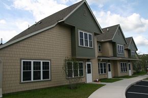 Easthampton apartment for rent - a green house with a sidewalk in front of it