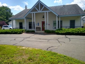 Wales apartment for rent - a white house with a driveway in front of it