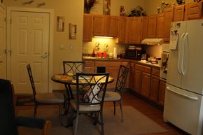 Ludlow apartment for rent - a kitchen with a table and chairs and a refrigerator
