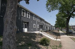 Holyoke townhouse for rent - a row of black buildings with trees and a sidewalk