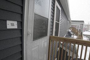 Holyoke townhouse for rent - a front door of a house with a balcony in the snow