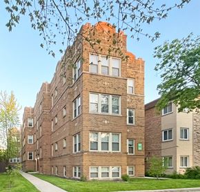 Oak Park apartment for rent - A tall brick apartment building with a green lawn in front.