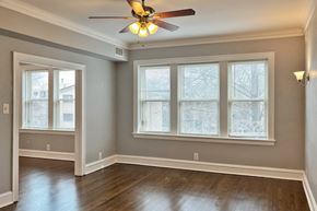 Oak Park apartment for rent - A room with a ceiling fan and a window.