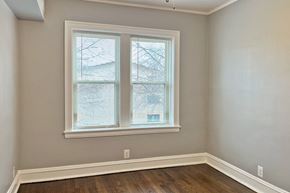 Oak Park apartment for rent - A room with a window and wooden floors.