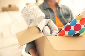 San Antonio apartment for rent - A person is unpacking a box with a gloved hand.