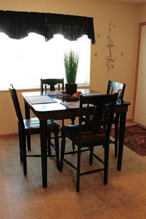 Shakopee apartment for rent - a dining table with four chairs in front of a window