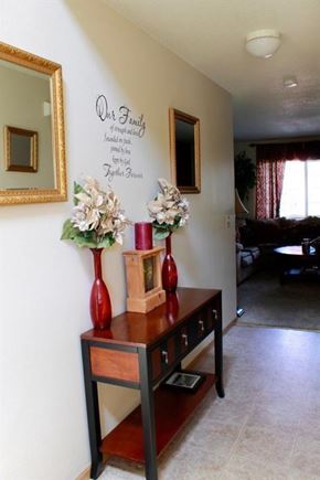Shakopee apartment for rent - a living room with two red vases on a table