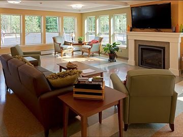 Saco apartment for rent - A living room with a fireplace and a television on the wall.