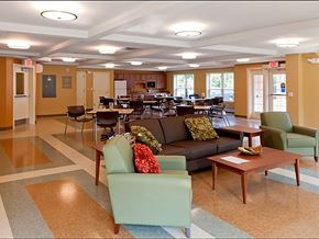 Saco apartment for rent - A large room with a couch, chairs, and tables.