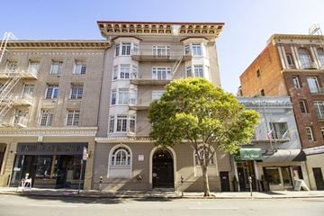 San Francisco apartment for rent - A tree in front of a building with a balcony.