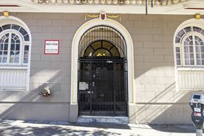 San Francisco apartment for rent - A building with a black gate and a red and white sign on the wall.