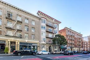 San Francisco apartment for rent - A street view of a city with cars parked on the side of the road.