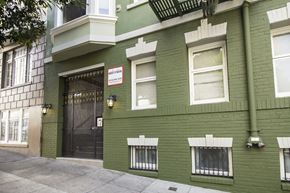 San Francisco apartment for rent - A green building with a black gate and a sign that says "Residential".