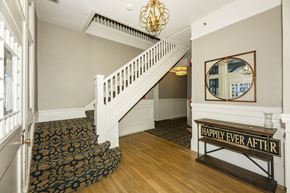 San Francisco apartment for rent - A staircase with a black and white carpet and a wooden banister.