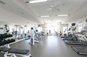 Shrewsbury apartment for rent - a gym with lots of exercise equipment and a ceiling fan