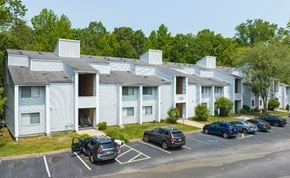 Lindenwold apartment for rent - A parking lot in front of a building with cars parked.