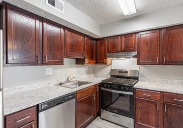 Lindenwold apartment for rent - A kitchen with wooden cabinets and a stainless steel dishwasher.