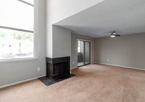 Lindenwold apartment for rent - A room with a fireplace and a ceiling fan.