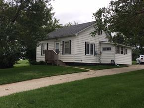 Emerson house for rent - a white house with a yard and a sidewalk