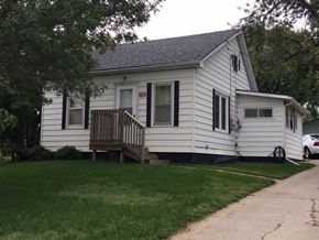 Emerson house for rent - a white house with a wooden deck on the side of it