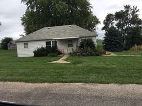 Thurston apartment for rent - A white house with a grey roof and a small garden in front.