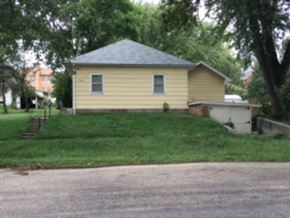 Thurston apartment for rent - a yellow house on a hill with a road and trees