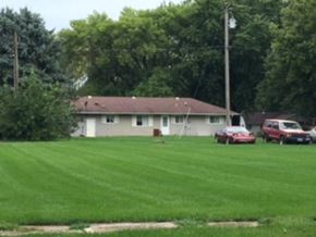 Rosalie apartment for rent - a house with cars parked in a field