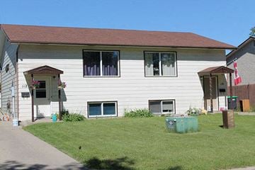 Brandon apartment for rent - a white house with a lawn in front of it